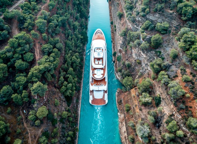 superyacht O'PTASIA cruising through the Corinth Canal on a Greece yacht charter